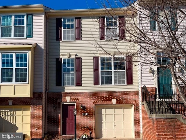 townhome / multi-family property featuring a garage