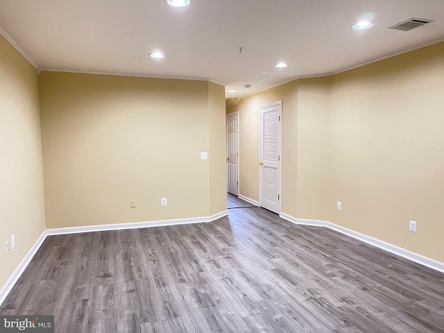 spare room featuring ornamental molding and hardwood / wood-style floors