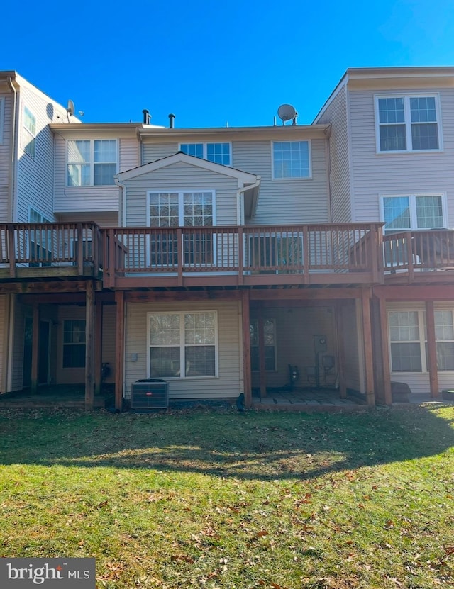 back of property featuring a wooden deck, a yard, central AC unit, and a patio area