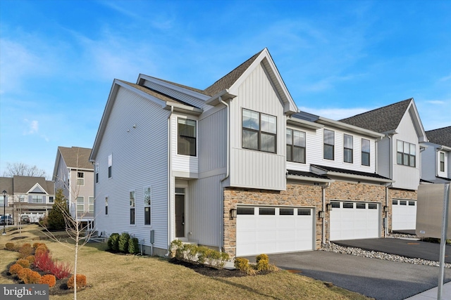 view of front of house featuring a garage and a front lawn