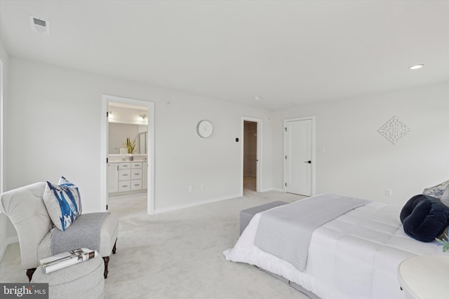 carpeted bedroom featuring ensuite bath