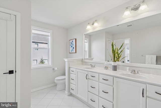 bathroom featuring tile patterned floors, vanity, and toilet