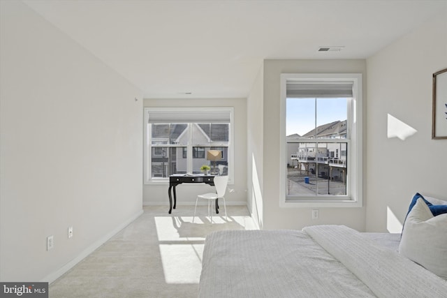 bedroom featuring light colored carpet