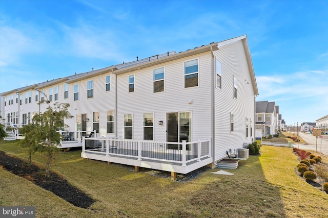 back of property featuring central AC, a deck, and a lawn