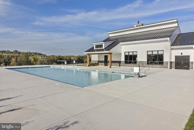 view of swimming pool featuring a patio area