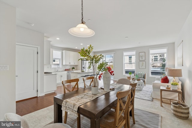 dining space featuring hardwood / wood-style flooring and sink