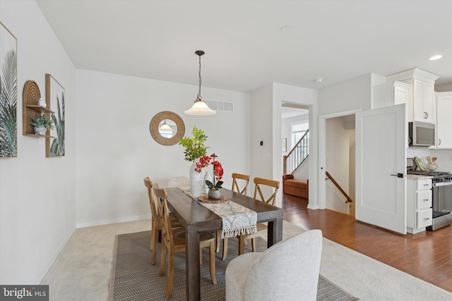 dining space with dark hardwood / wood-style floors