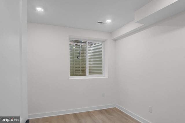 unfurnished room with light wood-type flooring