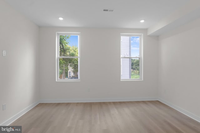 empty room with light hardwood / wood-style flooring