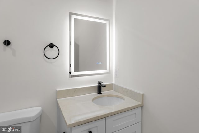 bathroom with vanity and toilet