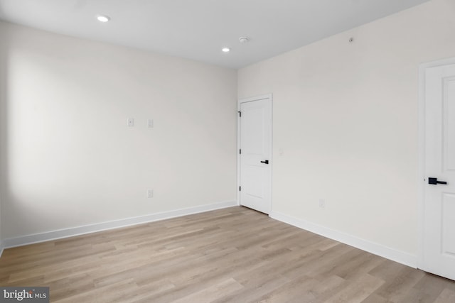 empty room with light hardwood / wood-style flooring