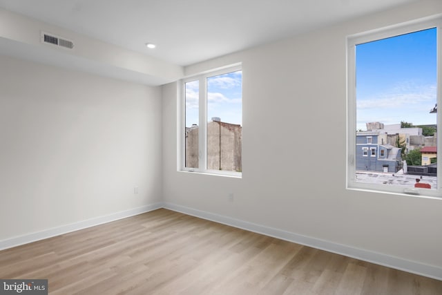 spare room featuring light hardwood / wood-style floors