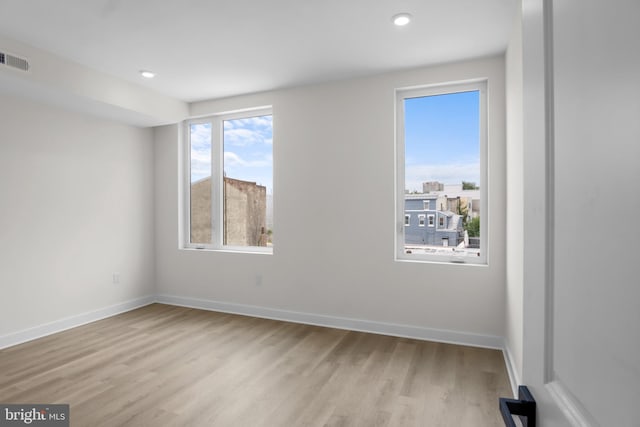 spare room featuring light hardwood / wood-style flooring