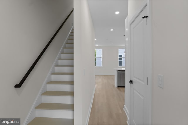 stairs with hardwood / wood-style flooring