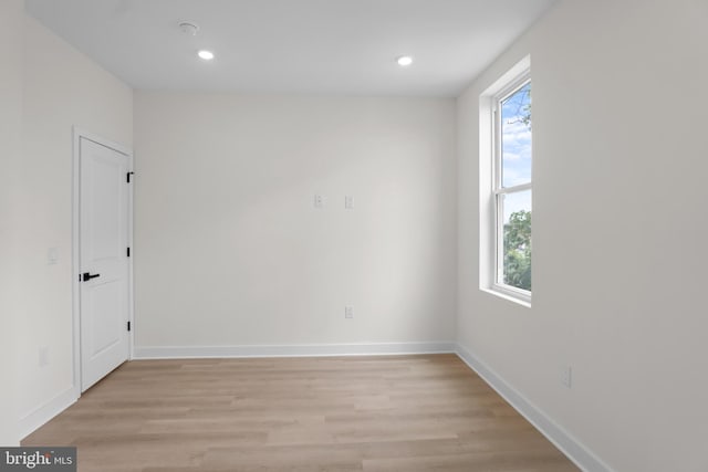 empty room with plenty of natural light and light wood-type flooring