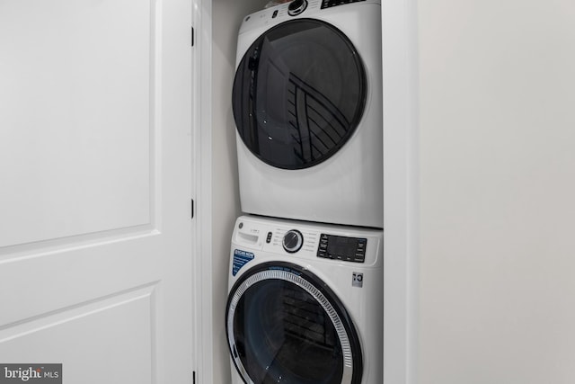 laundry area with stacked washer and dryer