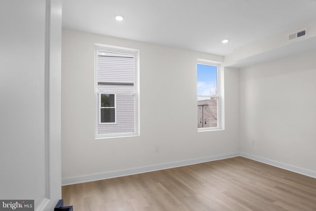 spare room featuring light hardwood / wood-style floors