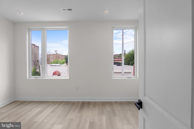 spare room with light hardwood / wood-style flooring