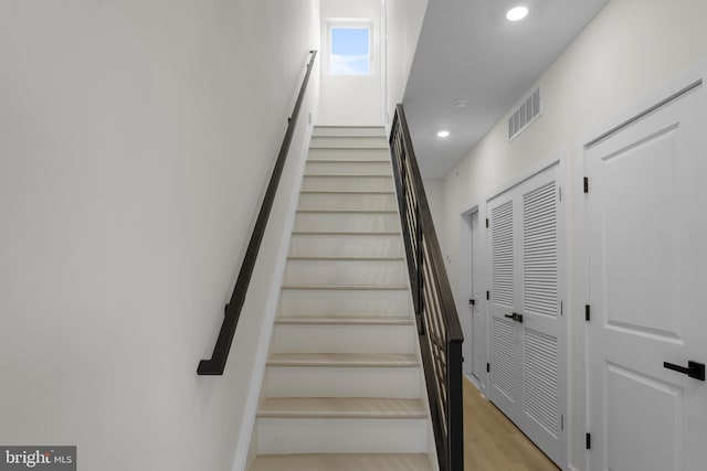 staircase featuring hardwood / wood-style flooring