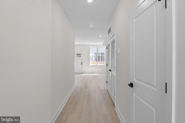 hall with light hardwood / wood-style floors