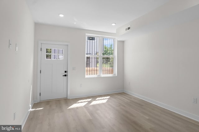 foyer entrance with light hardwood / wood-style floors