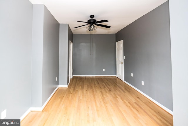 empty room with light hardwood / wood-style floors and ceiling fan