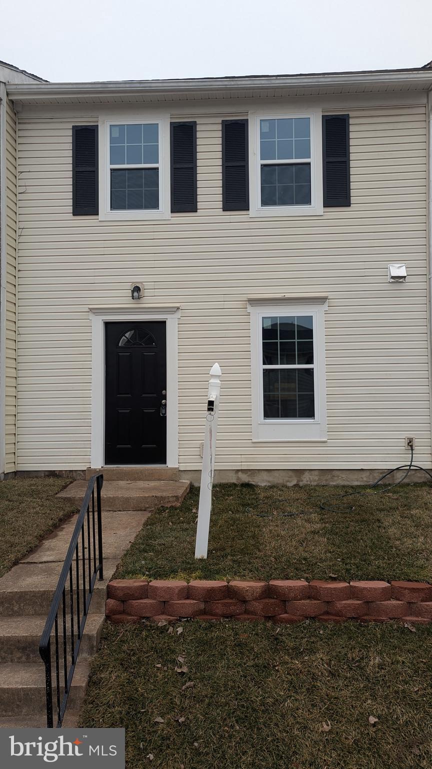 doorway to property featuring a yard