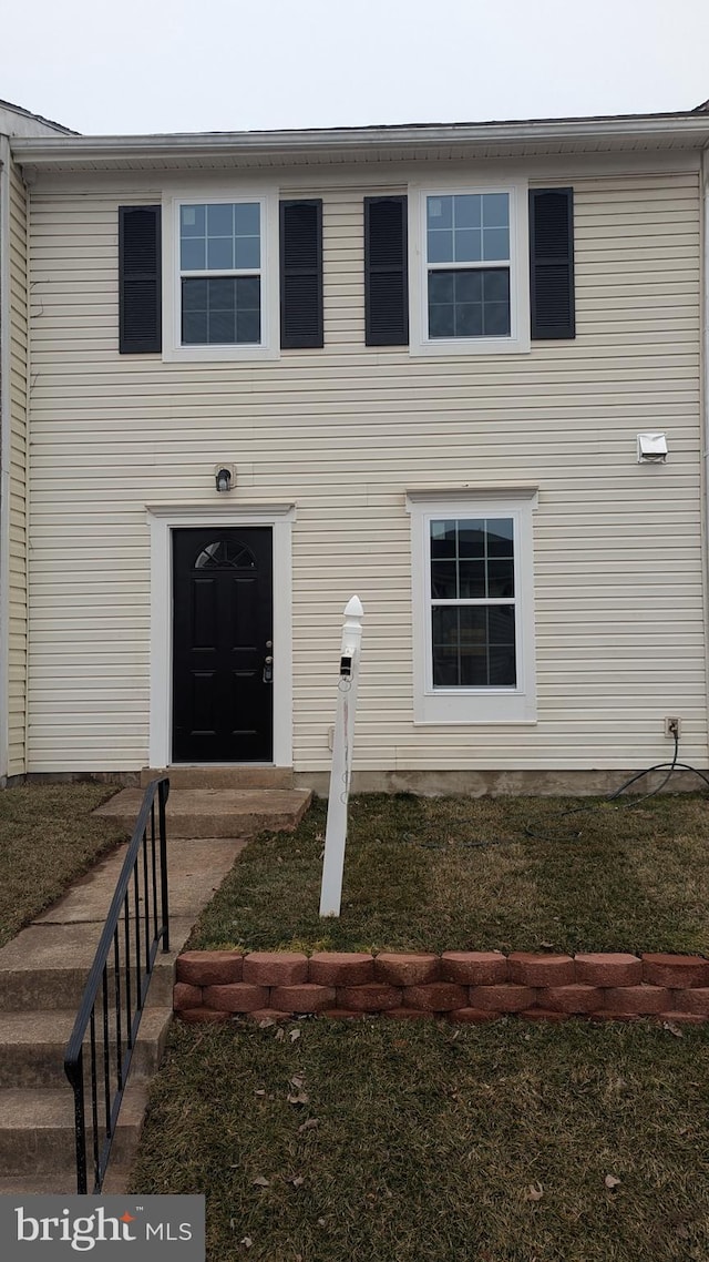 doorway to property featuring a yard