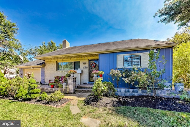 ranch-style house featuring a garage and a front yard