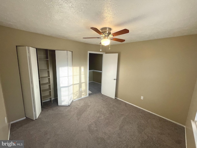 unfurnished bedroom featuring carpet, a closet, ceiling fan, a textured ceiling, and baseboards