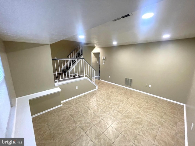 below grade area featuring stairway, recessed lighting, visible vents, and baseboards