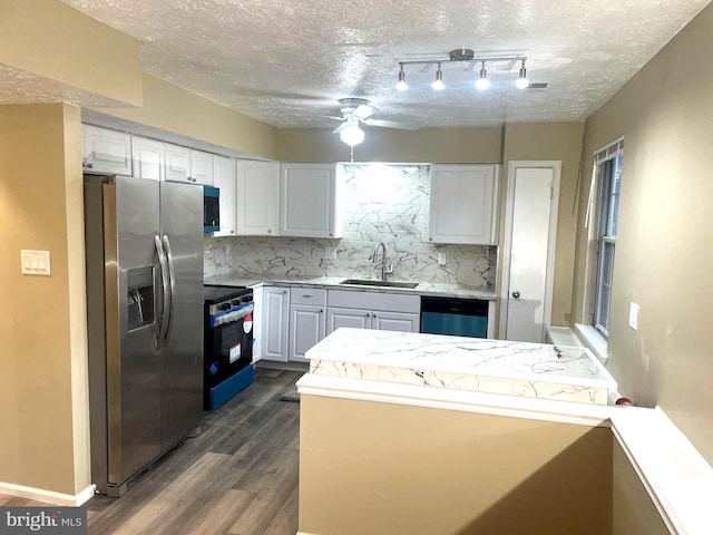 kitchen with appliances with stainless steel finishes, light countertops, white cabinets, and a sink