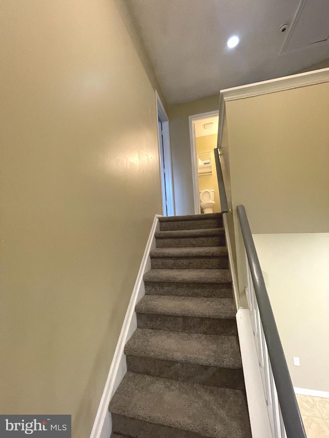 stairway featuring recessed lighting and baseboards