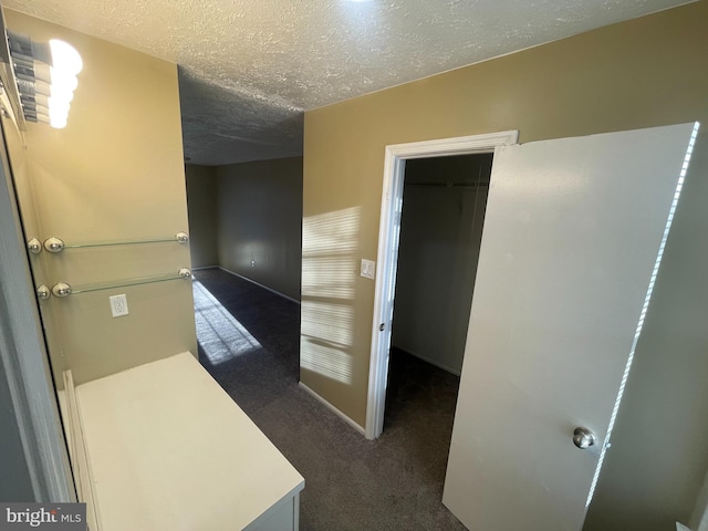 interior space with baseboards and a textured ceiling