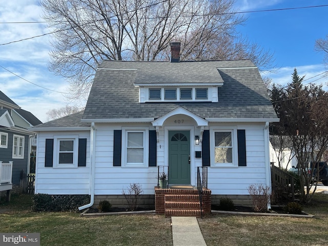 bungalow-style house featuring a front lawn