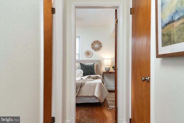 hallway with hardwood / wood-style flooring