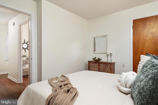 bedroom with dark hardwood / wood-style floors