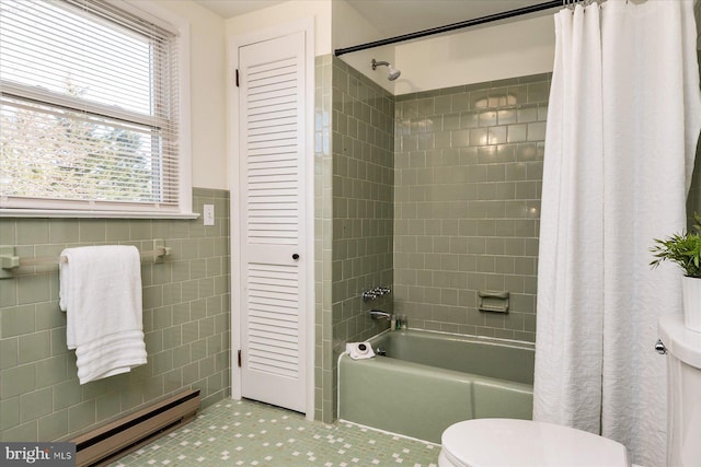 bathroom featuring tile patterned floors, toilet, tile walls, a baseboard radiator, and shower / bath combo with shower curtain