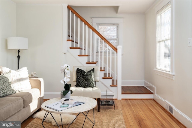 living room featuring plenty of natural light and light hardwood / wood-style flooring