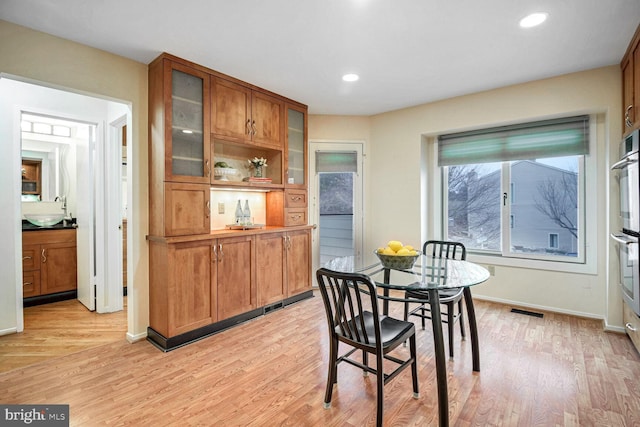 dining room featuring light hardwood / wood-style floors and sink