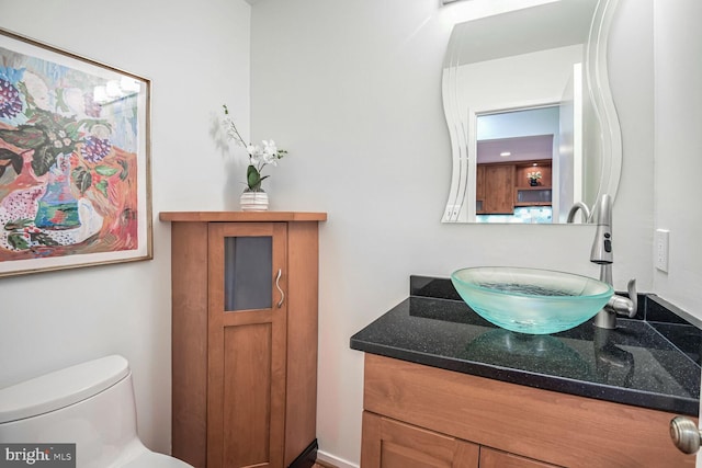 bathroom featuring vanity and toilet