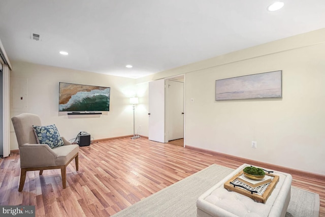 sitting room with wood-type flooring