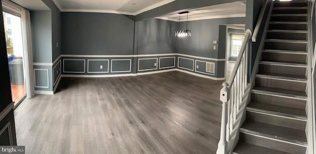 interior space with ornamental molding, wood-type flooring, and plenty of natural light