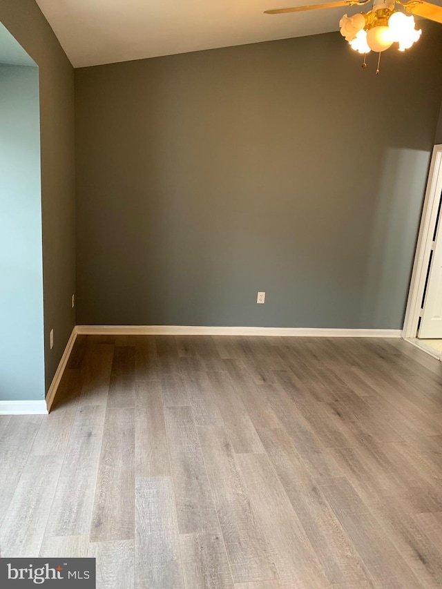 unfurnished room with hardwood / wood-style flooring and ceiling fan