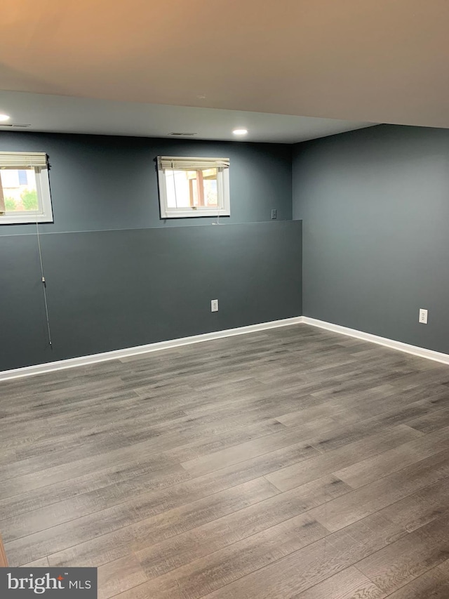 basement featuring light hardwood / wood-style floors and a wealth of natural light