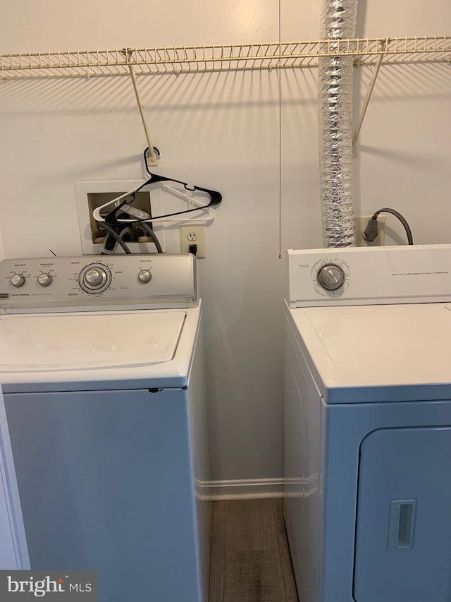 laundry room featuring hardwood / wood-style flooring and separate washer and dryer