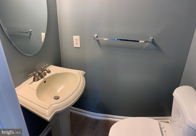 bathroom featuring hardwood / wood-style floors, sink, and toilet