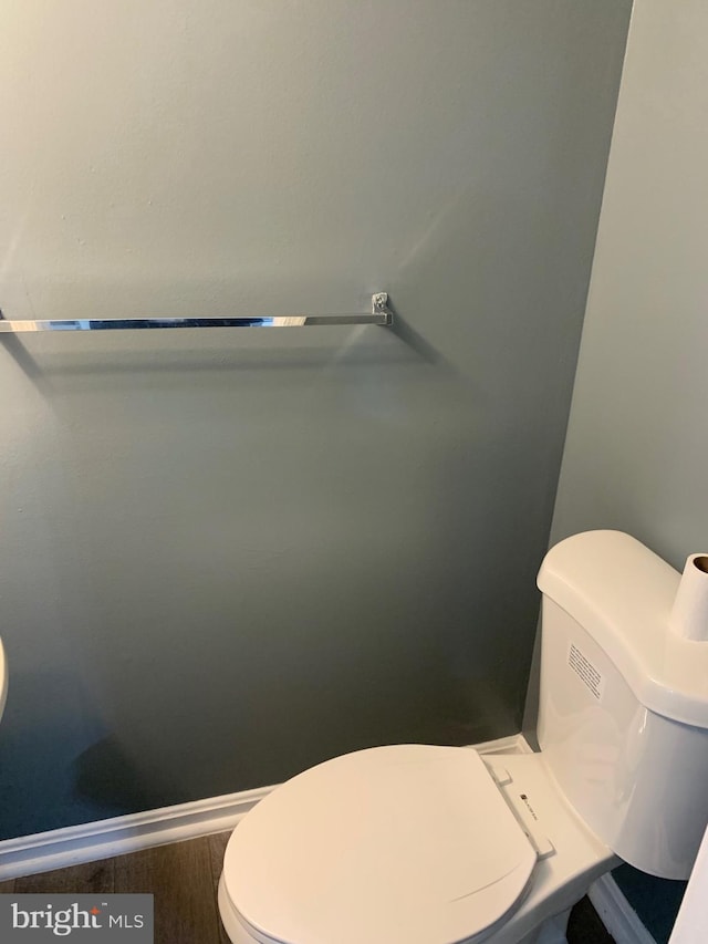 bathroom featuring wood-type flooring and toilet