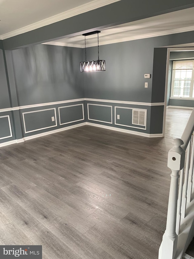 unfurnished dining area with ornamental molding and dark wood-type flooring