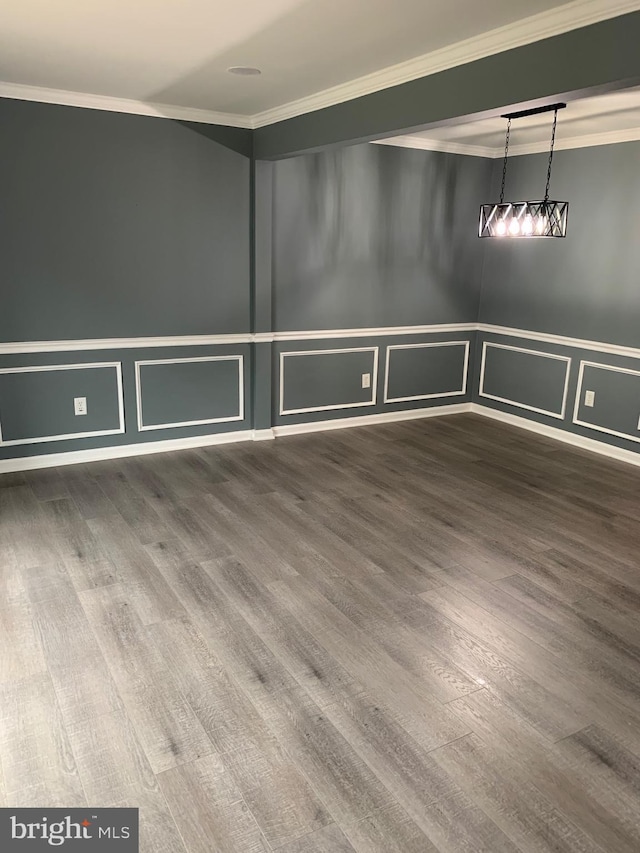 spare room featuring crown molding and hardwood / wood-style flooring